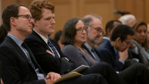 Joe Kennedy, Ben Sachs sitting with a group of people